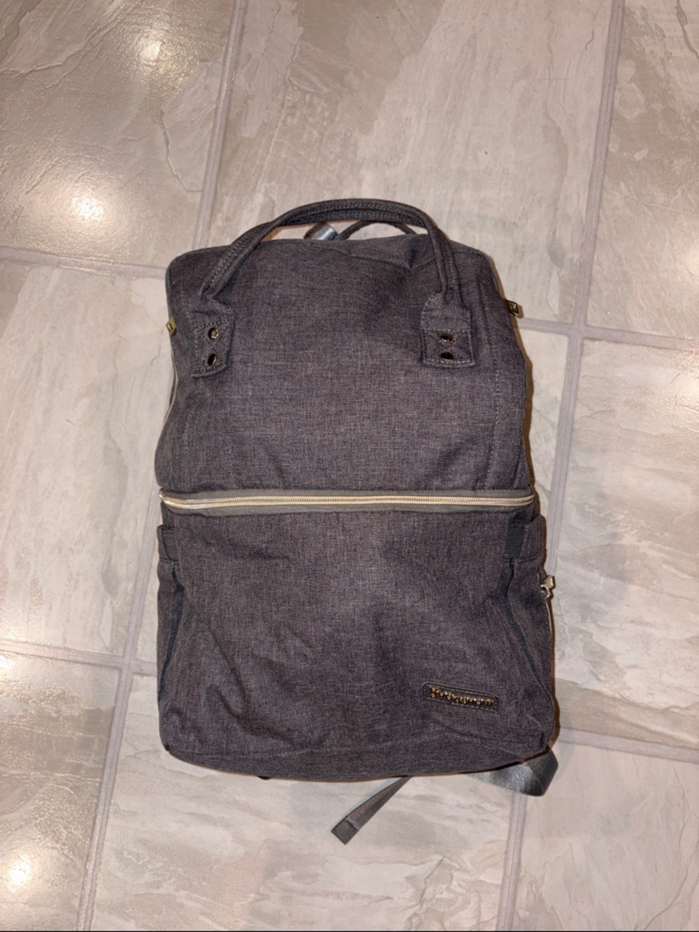 Grey breast pump and baby back pack. Multiple compartments.